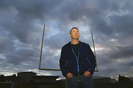 Former Bremerton High School assistant football coach Joe Kennedy stands on the field at Bremerton Memorial Stadium, Nov. 5, 2015. After the June 27, 2022 U.S. Supreme Court ruling in favor of the high school football coach’s right to pray on the field after games, there were predictions of sweeping consequences from across the ideological spectrum. But three months after the decision, there’s no sign that large numbers of coaches are following Kennedy’s high-profile example. (Larry Steaga