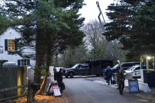 The access road to President Joe Biden's home in Wilmington, Del., is seen from the media van on Jan. 13, 2023. A new poll shows that more U.S. adults disapprove than approve of the way President Joe Biden has handled the discovery of classified documents at his home and former office. Yet that seems to have had little impact on Biden's overall approval rating. (AP Photo/Carolyn Kaster, File)