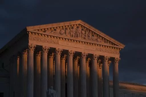 The Supreme Court is seen at sunset in Washington, on Jan. 24, 2019. The Supreme Court will be taking its first look in the 156-year history of the 14th Amendment at a provision, Section 3, that's meant to keep former officeholders who "engaged in insurrection" from ever regaining power. The stakes couldn't be higher in arguments taking place on Thursday, Feb. 8, 2024. (AP Photo/J. Scott Applewhite, File)