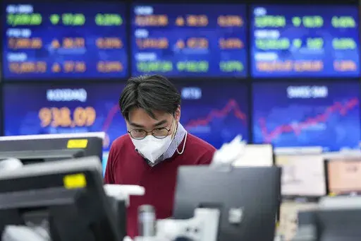A currency trader watches monitors at the foreign exchange dealing room of the KEB Hana Bank headquarters in Seoul, South Korea, Thursday, Jan. 20, 2022. Asian stock markets rose Thursday after China cut interest rates to shore up flagging economic growth and Japan reported a double-digit rise in exports. (AP Photo/Ahn Young-joon)