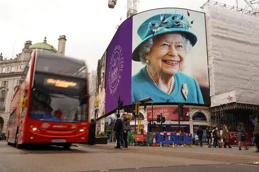 The screen in Piccadilly Circus is lit to celebrate the 70th anniversary of Britain's Queen Elizabeth's accession to the throne, in London, Sunday, Feb. 6, 2022.(AP Photo/Alberto Pezzali)