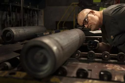 A steel worker inspects a 155 mm M795 artillery projectile during the manufacturing process at the Scranton Army Ammunition Plant in Scranton, Pa., Thursday, April 13, 2023. On Thursday, the Commerce Department issues its first of three estimates of how the U.S. economy performed in the first quarter of 2023. (AP Photo/Matt Rourke, File)