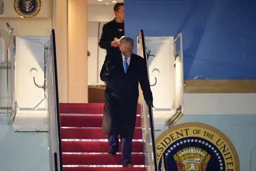 President Donald Trump, followed by Elon Musk, arrives on Air Force One, Wednesday, Feb. 19, 2025, at Joint Base Andrews, Md, after returning from Florida. (AP Photo/Mark Schiefelbein)