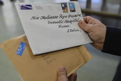 An employee of the Belsito postal distribution center in Rome sorts letters addressed to Pope Francis, who is currently being treated at Rome's Agostino Gemelli Polyclinic for bilateral pneumonia, Wednesday, March 19, 2025. (AP Photo/Chris Warde-Jones)