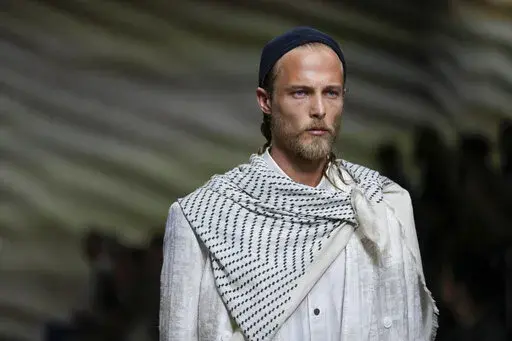 A model wears a creation as part of the Giorgio Armani men's Spring Summer 2023 collection presented in Milan, Italy, Monday, June 20, 2022. (AP Photo/Luca Bruno)