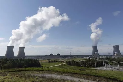 Nuclear reactors and cooling towers of the four units of Plant Vogtle, a nuclear plant near Waynesboro, Ga., are shown on July 31, 2023. Georgia Power Co. announced Thursday, Aug. 17, 2023, that Unit 4, at far right, is loading fuel, with the aim of sending power to the grid reliably by March 2024. Unit 4 and the now-operating Unit 3 and Unit 4 are the first new American reactors built from scratch in decades. (Arvin Temkar/Atlanta Journal-Constitution via AP, File)