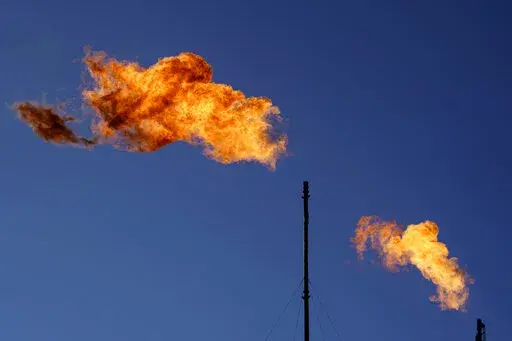 Flares burn off methane and other hydrocarbons at an oil and gas facility in Lenorah, Texas, Oct. 15, 2021. The U.N. Environment Programme said Friday, Nov. 11, that the new Methane Alert and Response System — MARS for short — is intended to help companies act on major emissions sources but also provide data in a transparent and independent way. (AP Photo/David Goldman, File)