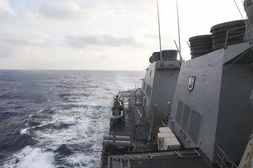 In this photo provided by the U.S. Navy, the Arleigh Burke-class guided-missile destroyer USS Milius (DDG 69) conducts routine underway operations in South China Sea, Friday March 24, 2023. China threatened “serious consequences” Friday, after the U.S. Navy sailed a destroyer around the disputed Paracel Islands in the South China Sea the second day in a row, which Beijing claimed was a violation of its sovereignty and security.(Mass Communication Specialist 1st Class Greg Johnson/U.S. Navy v