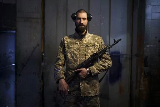 Sergiy Volosovets, 30, actor-turned-commander with the Territorial Defense Forces, poses for a photo in Brovary, on the outskirts of Kyiv, Ukraine, Wednesday, March 30, 2022. Volosovets now commands a unit of 11 men and oversees the military training of other volunteers at a base northeast of the capital, Kyiv. They are old, young, local, foreign, often new to war. Thousands of people have volunteered to join Ukraine’s Territorial Defense Forces and resist Russia’s invasion. The Associated P