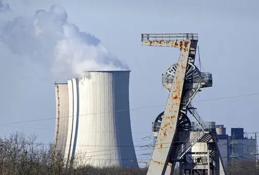 A winding tower of a closed coal mine rusts in front of a coal-fired power station Gelsenkirchen, Germany, Tuesday, March 8, 2022. Compared to the U.S., the 27-member European Union faces much stronger direct economic consequences than does the U.S. from Russia’s invasion of Ukraine and the resulting sanctions _ and that’s true above all when it comes to the oil and gas that fuels vehicles and keeps the heat and the lights on. (AP Photo/Martin Meissner, File)