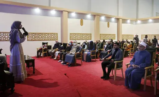 Al-Zahraa Layek Helmee recites an Islamic poem at the annual Cairo International Book Fair, in Cairo, Egypt, Feb. 4, 2022. For the 18-year-old, the high-profile recitation of Muslim holy text at a Cairo conference of the Organisation of Islamic Cooperation was a personal milestone -- one that she also hopes would send a message to women and girls: That can be you. “I wanted to prove that women have a great role to play when it comes to Quran recitation," she said. (AP Photo/Amr Nabil)