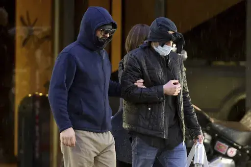 Former FBI informant Alexander Smirnov, left, walks out of his lawyer's office in downtown Las Vegas after being released from federal custody Feb. 20, 2024. (K.M. Cannon/Las Vegas Review-Journal via AP, File)