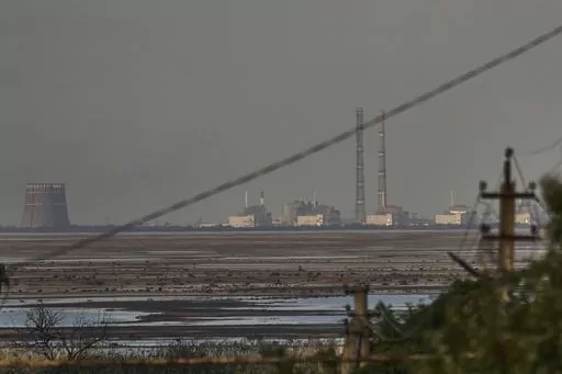 The Zaporizhzhia nuclear power plant, Europe's largest, is seen in the background of the shallow Kakhovka Reservoir after the dam collapse, in Energodar, Russian-occupied Ukraine, Tuesday, June 27, 2023. The U.N. atomic watchdog said in a statement late Monday, July 24, 2023, its staff at Ukraine’s Russian-occupied Zaporizhzhia Nuclear Power Plant report seeing anti-personnel mines around the site. The report comes as Kyiv pursues a counteroffensive against the Kremlin’s entrenched forces af