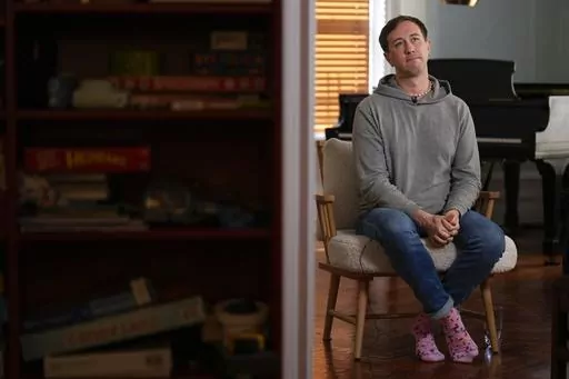 Samuel Schultz talks to reporters at his home, Monday, Oct. 9, 2023, in New York. It took eight years and the burgeoning #MeToo movement to spur them to go public and make a police report, and an additional five years for their attackers to plead guilty. Now, as much as Schultz hopes there’s a reckoning coming in gay and queer communities, too, it feels like they are the ones shouldering the blame, not the attackers: for coming forward, for harming the men’s reputations. (AP Photo/Seth Wenig