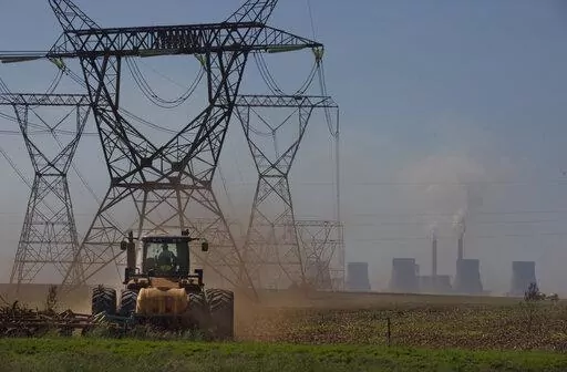 The land is ploughed under electrical pylons leading from a coal-powered electricity generating plant east of Johannesburg, Thursday, Nov. 17 2022. Living in the shadow of one of South Africa’s largest coal-fired power stations, residents of Masakhane fear job losses if the facility is closed as the country moves to cleaner energy. A significant polluter because it relies on coal to generate about 80% of its electricity, South Africa plans to reduce that to 59% by 2030 by phasing out some of i