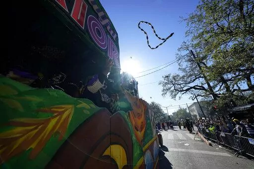 Members of the Krewe of Zulu parade throw beads from a float during Mardi Gras on Tuesday, March 1, 2022, in New Orleans. The lead-up to New Orleans’ annual Mardi Gras celebration is intensifying with events big and small. Three parades are set for Friday, Feb. 10, 2023 along historic St. Charles Avenue in New Orleans. (AP Photo/Gerald Herbert, File)