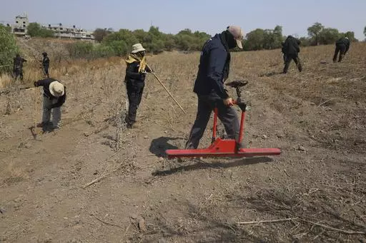A member of the Mexico City Search Commission uses a ground-penetrating radar in an area where volunteers said they have found a clandestine crematorium in Tlahuac, on the edge of Mexico City, Wednesday, May 1, 2024. Ceci Flores, a leader of one of the groups of so-called "searching mothers" from northern Mexico, announced late Tuesday that her team had found bones around clandestine burial pits and ID cards, and prosecutors said they were investigating to determine the nature of the remains. (A