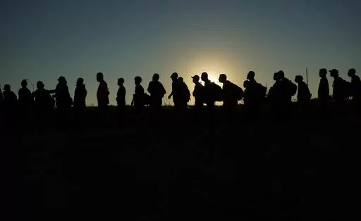 Migrants who crossed the Rio Grande and entered the U.S. from Mexico are lined up for processing by U.S. Customs and Border Protection, on Saturday, Sept. 23, 2023, in Eagle Pass, Texas. The U.S.-Mexico border and immigration are creating political and security challenges for President Joe Biden. Even some of his top allies worry about those issues' effects on his reelection chances. (AP Photo/Eric Gay, File)