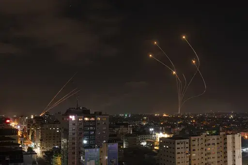 Rockets fired from Gaza and intercepted by Israel's Iron Dome anti-missile system over Israeli skies are seen from Gaza City, on May 13, 2023. (AP Photo/Fatima Shbair, File)