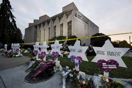 A makeshift memorial stands outside the Tree of Life Synagogue in the aftermath of a deadly shooting in Pittsburgh, Oct. 29, 2018. The man charged in the deadliest antisemitic attack in U.S. history has for years been trying unsuccessfully to avoid having a federal jury decide whether to convict him of shooting to death 11 people during services in a Pittsburgh synagogue, a trial scheduled to get underway with jury selection in less than two weeks. (AP Photo/Matt Rourke, File)