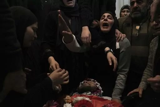 CORRECTS DETAILS OF DEATH Relatives mourn 17-year-old American Tawfiq Ajaq at his funeral in his family’s Palestinian home village in Al-Mazra'a ash-Sharqiya, West Bank, Saturday, Jan. 20, 2024. Ajaq was killed Friday by Israeli fire and police say they have launched an investigation. (AP Photo/Nasser Nasser)