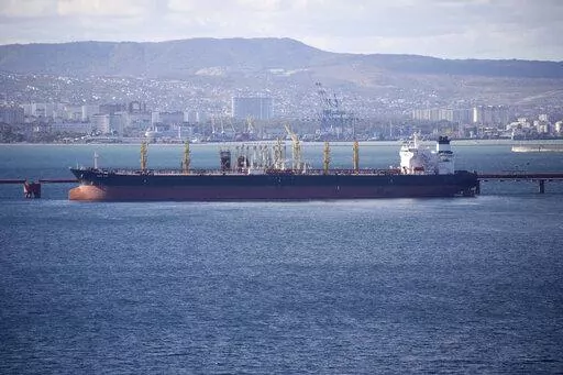 An oil tanker is moored at the Sheskharis complex, part of Chernomortransneft JSC, a subsidiary of Transneft PJSC, in Novorossiysk, Russia, on Oct. 11, 2022. A Russian official says the country will will cut oil production by 500,000 barrels per day next month in response to the West capping the price of its crude over the war in Ukraine. According to multiple Russian news media reports, Deputy Prime Minister Alexander Novak said Friday, Feb. 10, 2023 that “we will not sell oil to those who di