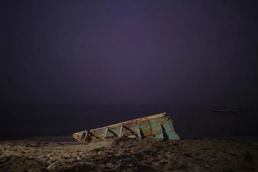 The wreck of a traditional Mauritanian fishing boat, known as a pirogue, also used by migrants to reach Spain's Canary Islands, sits on a beach near Nouadhibou, Mauritania, Thursday, Dec. 2, 2021. In 2021, at least seven boats appearing to be from Northwest Africa washed up in the Caribbean and in Brazil. All carried dead bodies. (AP Photo/Felipe Dana)