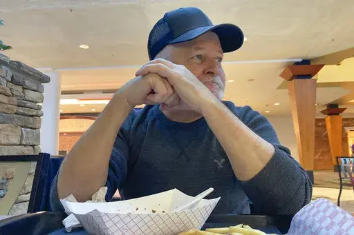 Craig Prichard, 65, of Des Moines, Iowa, who voted for Donald Trump in 2016, but says he voted for Joe Biden in 2020 believing Trump had failed to the confront the coronavirus pandemic, talks on Jan. 10, 2022. The retired factory worker says he is "satisfied" with Biden, crediting him for tackling several problems simultaneously. "You can tell he's trying to handle the pandemic, food prices, gas prices, Russia, all at the same time. And he doesn't seem to care how he looks," Prichard, a politica