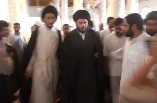 Muqtada al-Sadr is seen during prayers at the Al-Kufa Mosque Friday, July 18, 2003, in the holy city of Najaf, south of Baghdad, Iraq. Al-Sadr is a populist cleric, who emerged as a symbol of resistance against the U.S. occupation of Iraq after the 2003 invasion. (AP Photo/Wally Santana, File)