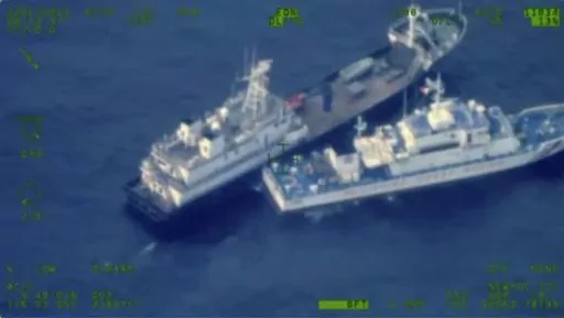 This image released by the Armed Forces of the Philippines, shows a Chinese militia vessel, top, and Philippine coast guard vessel BRP Cabra as they approach Second Thomas Shoal, locally called Ayungin Shoal, at the disputed South China Sea on Sunday Oct. 22, 2023. (Armed Forces of the Philippines via AP)