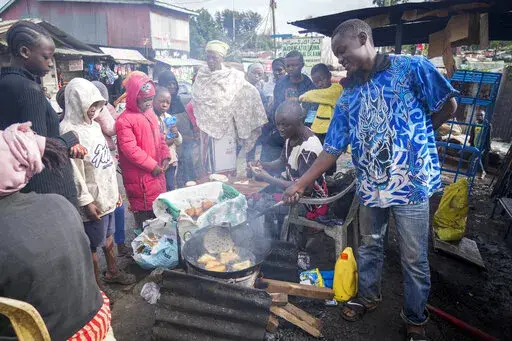 A man uses cooking oil to fry Mandazi, a type of fried bread, on a street in the low-income Kibera neighborhood of Nairobi, Kenya, Wednesday, April 20, 2022. Global cooking oil prices have been rising since the COVID-19 pandemic began and Russia's war in Ukraine has sent costs spiralling. It is the latest fallout to the global food supply from the war, with Ukraine and Russia the world’s top exporters of sunflower oil. And it's another rising cost pinching households and businesses as inflatio