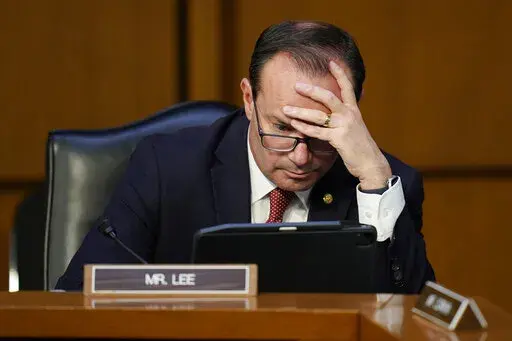 Sen. Mike Lee, R-Utah, looks to a tablet during Supreme Court nominee Judge Ketanji Brown Jackson's confirmation hearing before the Senate Judiciary Committee Tuesday, March 22, 2022, on Capitol Hill in Washington. (AP Photo/Carolyn Kaster)