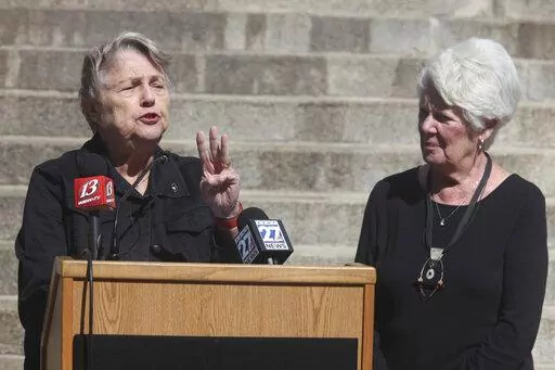 Former Kansas Democratic Party Chair and state Revenue Secretary Joan Wagnon, left, speaks during a rally for a new group, Keep Kansas Free, while former Insurance Commissioner Sandy Praeger, right, a Republican, watches on Thursday, Oct. 13, 2022, outside the statehouse in Topeka, Kan. The group formed to urge voters who support abortion rights to back like-minded candidates and retain Kansas Supreme Court justices on the bench as ways to protect abortion access. (AP Photo/John Hanna)