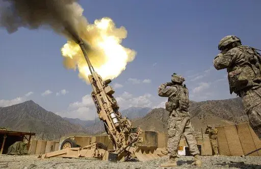A 155mm round is fired from a 777 Howitzer canon at insurgents during a firing mission by soldiers with 2nd Platoon, Charlie Battery, 3rd Battalion, 321 Field Artillery Regiment out of Fort Bragg, N.C., July 8, 2011, at Forward Operating Base Bostick in Kunar province, Afghanistan. The Biden administration's decision to dramatically ramp up delivery of artillery guns to Ukraine eight weeks into the war signals a deepening American military commitment at a pivotal stage of fighting for the countr
