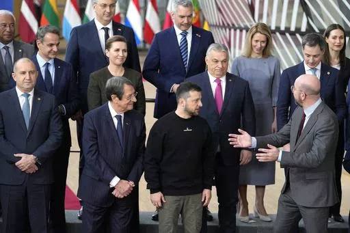 European Council President Charles Michel, front right, speaks with Ukraine's President Volodymyr Zelenskyy, front second right, and Hungary's Prime Minister Viktor Orban, second row center, as they pose with other European Union leaders for a group photo at an EU summit in Brussels on Thursday, Feb. 9, 2023. The European Union decided Thursday, Dec. 14, 2023 to open accession negotiations with Ukraine, a stunning reversal for a country at war that had struggled to find the necessary backing for