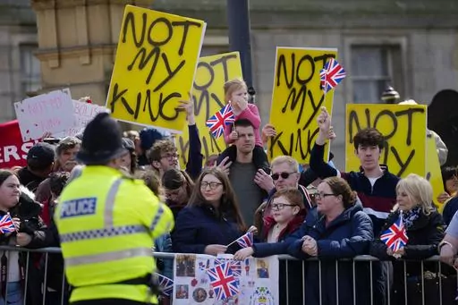 Protestors wait for the arrival of King Charles III and Camilla, the Queen Consort to visit Liverpool Central Library, and to officially mark the Library's twinning with Ukraine's first public Library, the Regional Scientific Library in Odesa, in Liverpool, England, Wednesday, April 26, 2023. There will be dissenters among the cheering crowds when King Charles III travels by gilded coach to his coronation. More than 1,500 protesters will be dressed in yellow for maximum visibility and they plan 