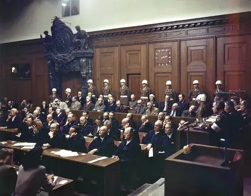 Defendants listen to part of the verdict in the Palace of Justice during the Nuremberg War Crimes Trial in Nuremberg, Germany on Sept. 30, 1946. Seated in the first row in the prisoner's dock are, from left: Hermann Goering, wearing dark glasses; Rudolf Hess; Joachim von Ribbentrop; Wilhelm Keitel; Ernest Kaltenbrunner; Alfred Rosenberg; Erich Raeder, wearing dark glasses; Wilhelm Frick; Julius Streicher;and Walter Funk. In the back row in front of the police guards are, from left: Karl Doenitz;