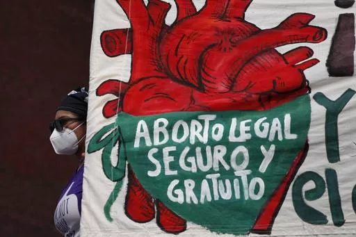 A woman holds a banner reading in Spanish, "Legal, safe, and free abortion" as abortion rights protesters demonstrate in front of the National Congress on the "Day for Decriminalization of Abortion in Latin America and the Caribbean," in Mexico City, Sept. 28, 2020. Mexico’s Supreme Court ruled in 2023 that national laws prohibiting abortions are unconstitutional and violate women’s rights. (AP Photo/Rebecca Blackwell, File)