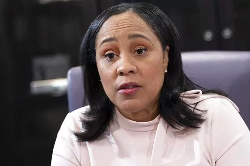 Fulton County Georgia District Attorney Fani Willis is photographed in her office in Atlanta, on Jan. 4, 2022. Willis, the prosecutor investigating whether former President Donald Trump and others illegally tried to interfere in the 2020 election in Georgia has indicated that she's interested in a breach of voting equipment in a county about 200 miles south of her Atlanta office. (AP Photo/Ben Gray, File)