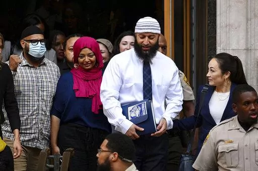 FILE — Adnan Syed, center right, leaves the courthouse after a hearing on Sept. 19, 2022, in Baltimore. Syed, who was released from a Maryland prison this year after his case was the focus of the true-crime podcast “Serial,” has been hired by Georgetown University as a program associate for the university's Prisons and Justice Initiative, the university said Wednesday, Dec. 21, 2022. (Jerry Jackson/The Baltimore Sun via AP, File)