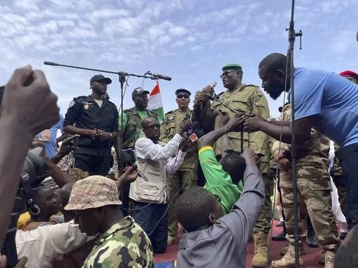 Mohamed Toumba, one of the soldiers who ousted Nigerian President Mohamed Bazoum, addresses supporters of Niger's ruling junta in Niamey, Niger, Sunday, Aug. 6, 2023. Nigeriens are bracing for a possible military intervention as time's run out for its new junta leaders to reinstate the country's ousted president. (AP Photo/Sam Mednick)