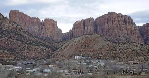 Hildale, Utah, is pictured sitting at the base of Red Rock Cliff mountains, with its sister city, Colorado City, Ariz., in the foreground on Dec. 16, 2014. On Tuesday, March 19, 2024, a businessman pleaded guilty to conspiring with the leader of an offshoot polygamous sect in the Colorado City-Hildale area to transport underage girls across state lines for sexual activity. The guilty plea by 53-year-old Moroni Johnson marked the first man to be convicted in what authorities say was a scheme to o