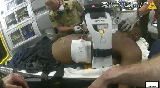 This image from police body camera video shows emergency personal tending to George Floyd after he had been loaded into an ambulance on May 25, 2020, in Minneapolis. A paramedic who treated Floyd on the day he was killed testified Wednesday, Jan. 26, 2022 at the federal civil rights trial of three former Minneapolis police officers that he wasn't told Floyd wasn't breathing and had no pulse when officers upgraded the urgency of an ambulance call. (Minneapolis Police Department via AP, File)