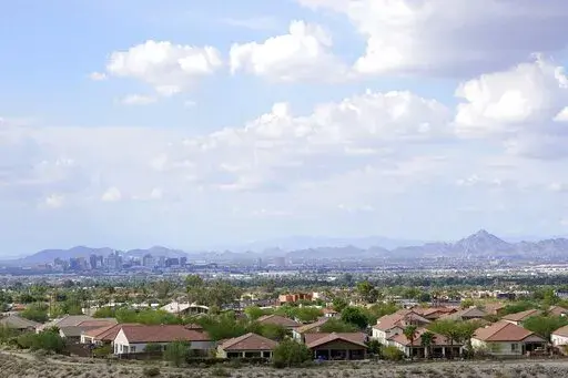 FILE -With the downtown skyline in the background, expansive urban sprawl continues to grow, Thursday, Aug. 12, 2021, in Phoenix. A county in the heart of metro Phoenix and several counties in Texas' fastest-growing metro areas had the biggest jumps in the numbers of white, Black, Asian and Hispanic residents last year, while California's Inland Empire also had among the biggest booms in Hispanic residents, according to new estimates released Thursday, June 30, 2022 (AP Photo/Ross D. Franklin, F