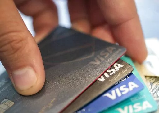 This Aug. 11, 2019 file photo shows Visa credit cards in New Orleans. With interest rates rising, the cost of borrowing is going up. This is especially the case for credit cards, as they have high annual percentage rates that vary as interest rates change.  (AP Photo/Jenny Kane, File)