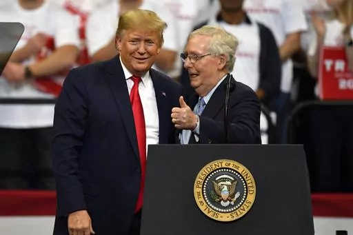 President Donald Trump, left, and Senate Majority Leader Mitch McConnell of Ky., greet each other during a campaign rally in Lexington, Ky., Nov. 4, 2019. McConnell is the highest ranking Republican in Congress who has yet to endorse Donald Trump's bid to return to the White House. But that's potentially about to change. McConnell's political team and Trump's campaign have been in talks over a possible endorsement and a strategy to unite Republicans on the party's ticket for the November electio