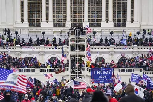 Insurrectionists loyal to President Donald Trump breach the U.S. Capitol in Washington, on Jan. 6, 2021. Rachel Marie Powell, a Pennsylvania woman who used a bullhorn to direct rioters attacking the U.S. Capitol has been convicted of charges that she joined the mob in an attempt to keep President Joe Biden out of the White House. (AP Photo/John Minchillo, File)
