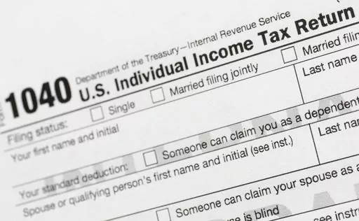 A portion of the 1040 U.S. Individual Income Tax Return form is shown July 24, 2018, in New York. The IRS has been tasked with looking into how to create a government-operated electronic free-file tax return system for all. Congress has directed the IRS to report in on how such a system might work. (AP Photo/Mark Lennihan, File)