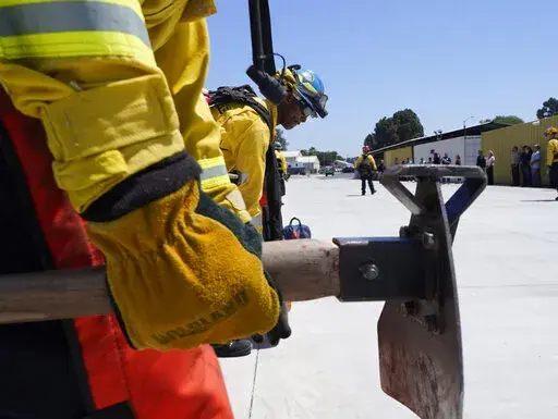 Cadets, who were formerly-incarcerated firefighters, train at the Ventura Training Center (VTC) during an open house media demonstration Thursday, July 14, 2022, in Camarillo, Calif. California has a first-in-the nation law and a $30 million training program both aimed at trying to help former inmate firefighters turn pro after they are released from prison. The 18-month program is run by Cal Fire, the California Conservation Corps, the state corrections department and the nonprofit Anti-Recidiv