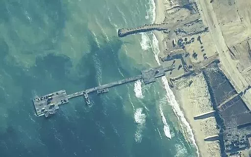 The image provided by U.S, Central Command, shows U.S. Army soldiers assigned to the 7th Transportation Brigade (Expeditionary), U.S. Navy sailors assigned to Amphibious Construction Battalion 1, and Israel Defense Forces placing the Trident Pier on the coast of Gaza Strip on May 16, 2024. A key section of the U.S. military-built pier designed to carry badly needed aid into Gaza by boat has been reconnected to the Gaza beach following storm damage repairs and aid will begin to flow soon, the U.S